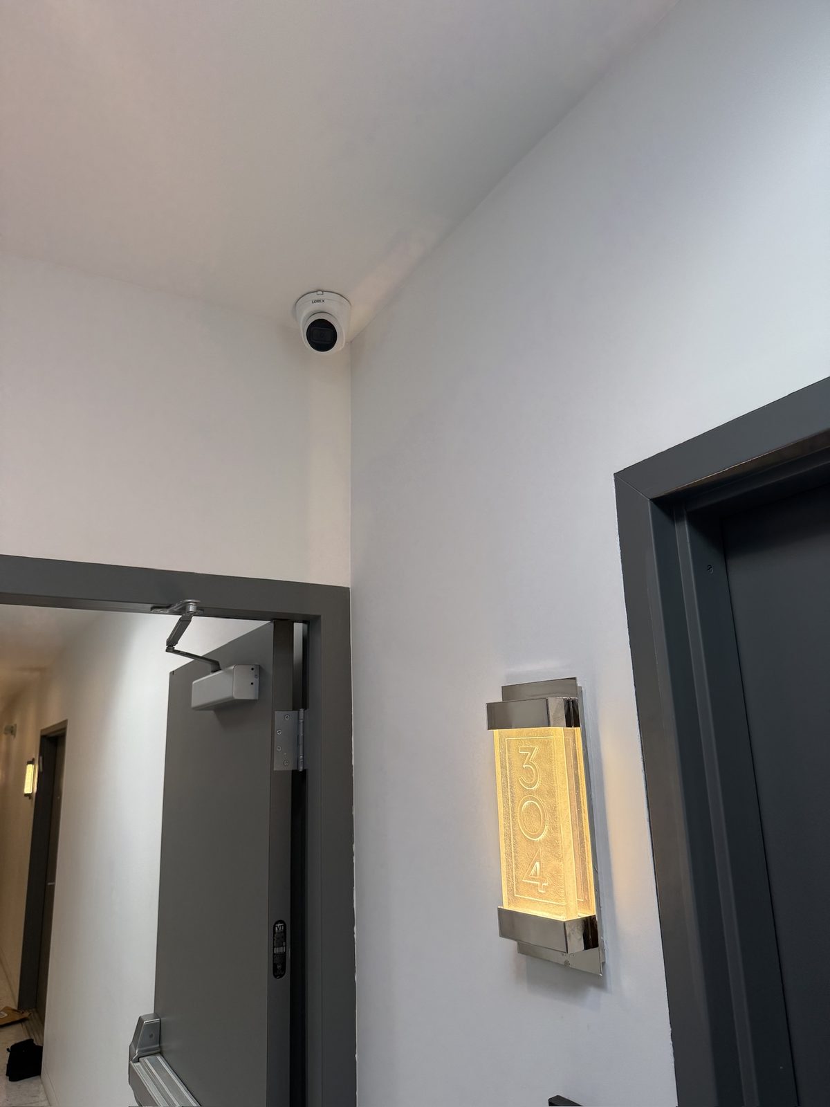 Dome cameras covering corridors, entries, and common areas in a multi-unit building.