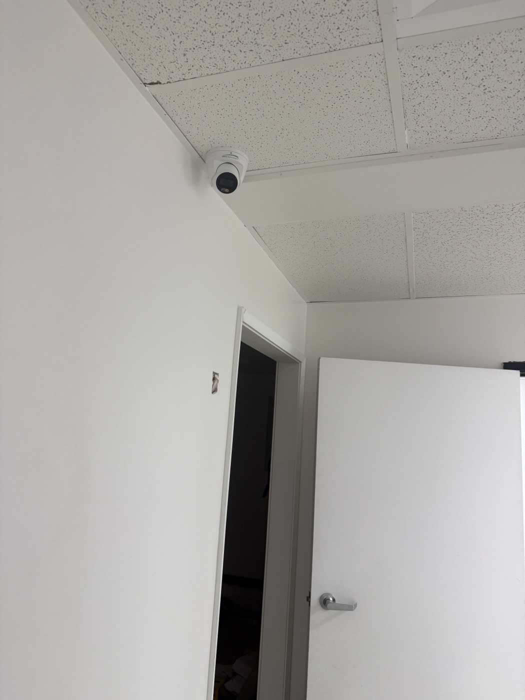 Turret security camera installed above an interior doorway in a dental office