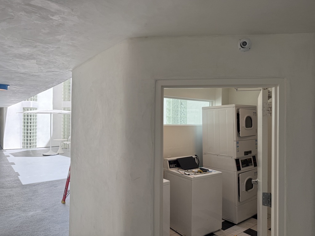 Camera installed above a shared laundry-room entrance.